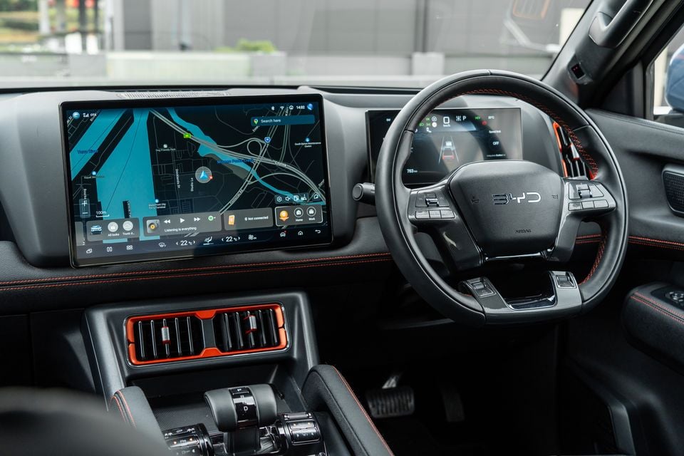 Dashboard of the 2026 BYD Shark 6 Premium ute, showing the steering wheel, digital driver display and large central touchscreen with navigation map