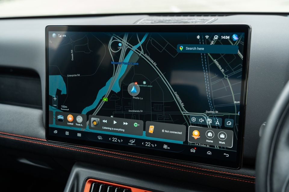 Touchscreen infotainment display in the 2026 BYD Shark 6 showing a navigation map, media controls and climate settings