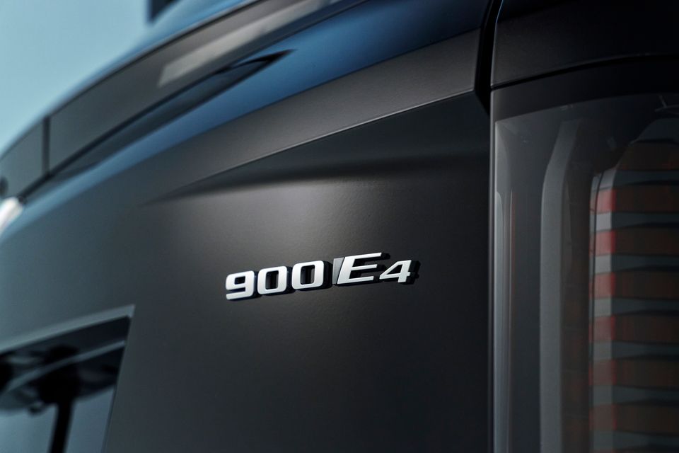 Close-up of the 900E4 badge on the rear of a dark-coloured 2026 Cadillac Vistiq Platinum, with a tail light visible to the right