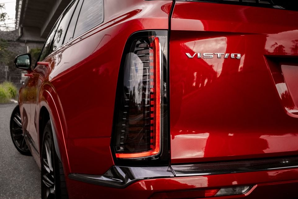 Close-up of the rear tail light and badge on a red Cadillac Vistiq SUV