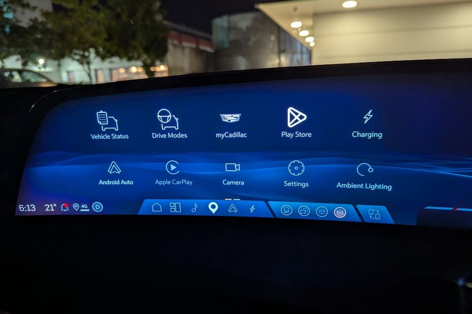 Cadillac Vistiq infotainment touchscreen showing the main menu with options including Drive Modes, myCadillac, Play Store, Charging, Android Auto, Apple CarPlay, Camera, Settings, and Ambient Lighting