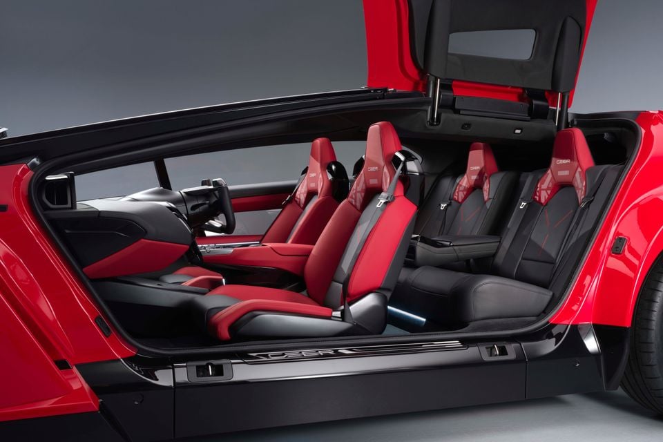 A red 2026 Ceer sedan shown with its gullwing-style doors open, revealing red and black leather front and rear seats