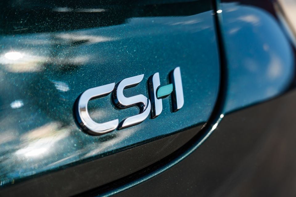 Close-up of the CSH badge on a blue Chery Tiggo 9 Super Hybrid