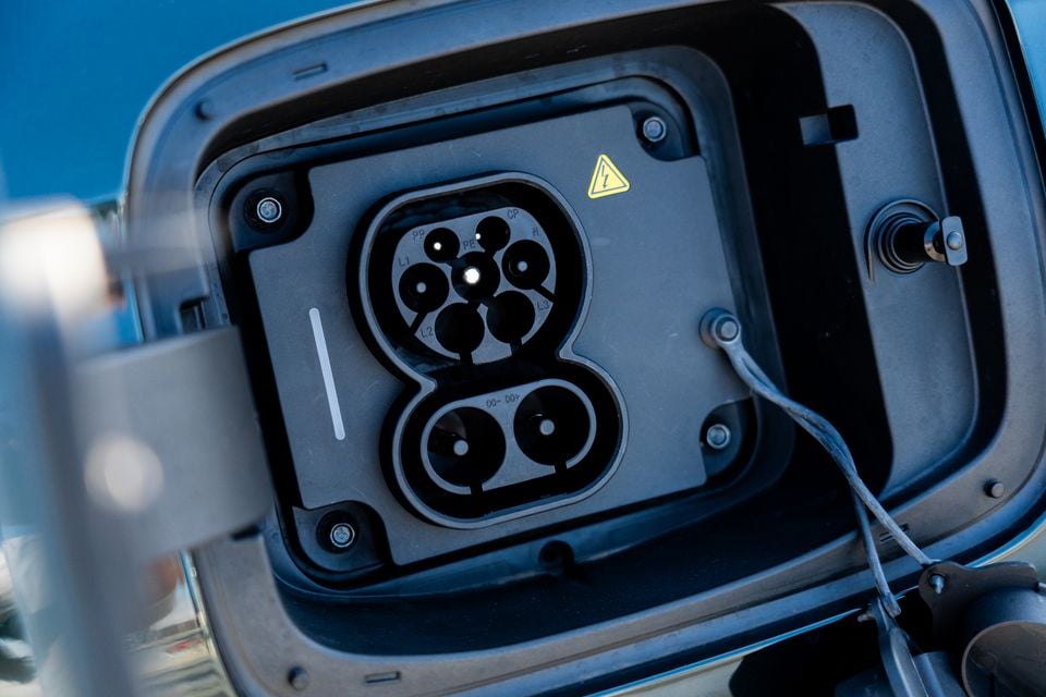 Close-up of a CCS (Combined Charging System) Type 2 charge port on the 2026 Chery Tiggo 9 Super Hybrid, with the port cover open revealing AC and DC charging connectors