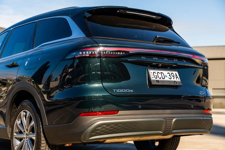 Rear view of a dark green Chery Tiggo 9 CSH SUV with an Australian NSW number plate, showing tail lights and badging