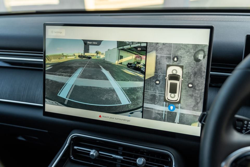 The infotainment touchscreen in a 2026 Chery Tiggo 9 showing the rear-view camera feed and a 3D surround-view camera display