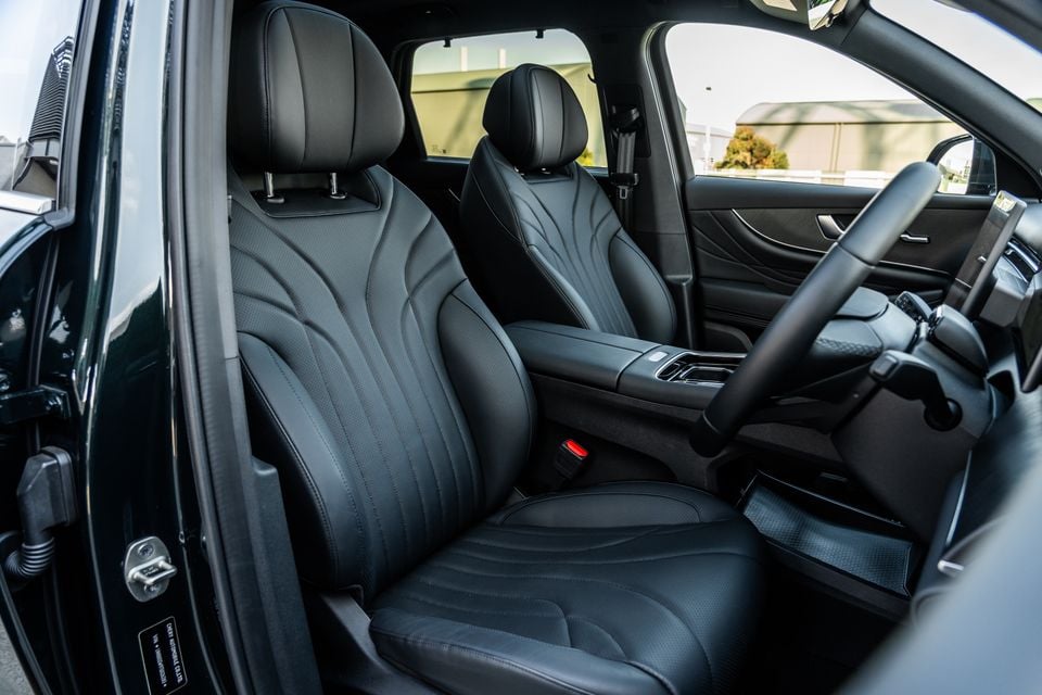 Black leather front seats of the 2026 Chery Tiggo 9 Super Hybrid, viewed from the open driver's door showing the cabin interior
