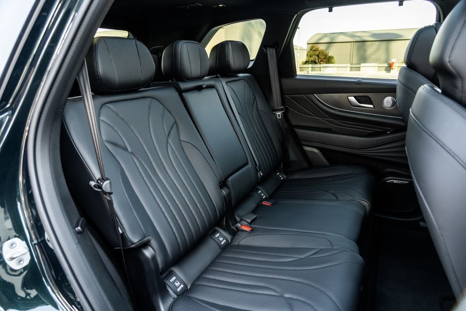 Rear interior of the 2026 Chery Tiggo 9 Super Hybrid showing three black leather seats with seatbelts and fold-down armrest