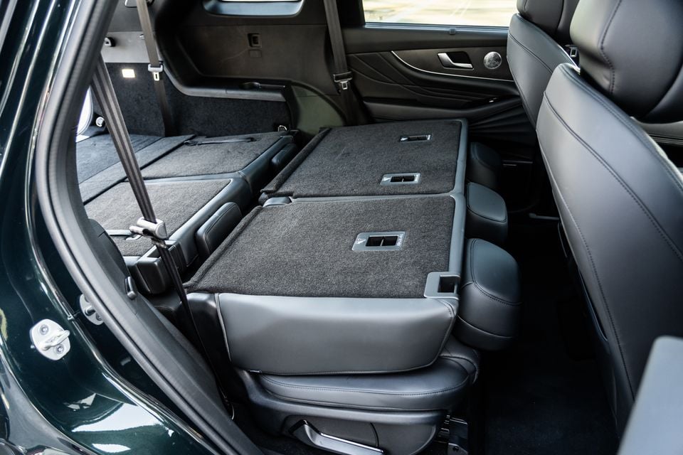 Interior of a 2026 Chery Tiggo 9 SUV showing the second and third-row seats folded flat to create a large cargo area, viewed from the rear door opening