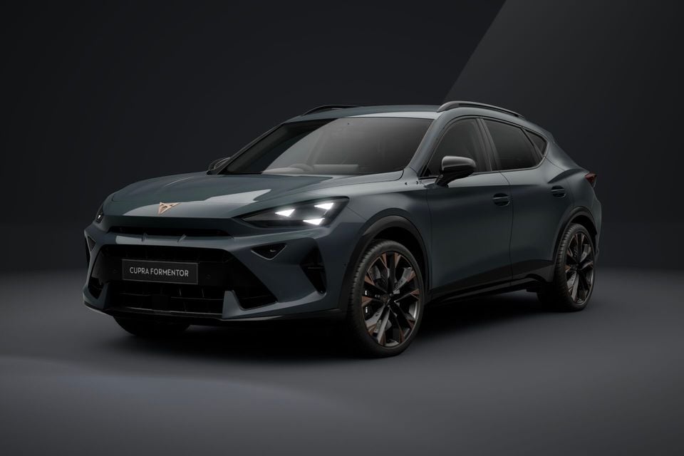 A dark teal 2026 Cupra Formentor SUV seen from the front three-quarter angle in a studio setting
