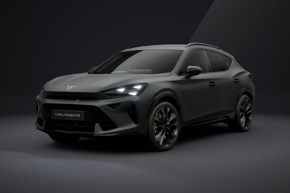 A dark grey matte Cupra Formentor SUV shown from a front three-quarter angle in a studio setting.