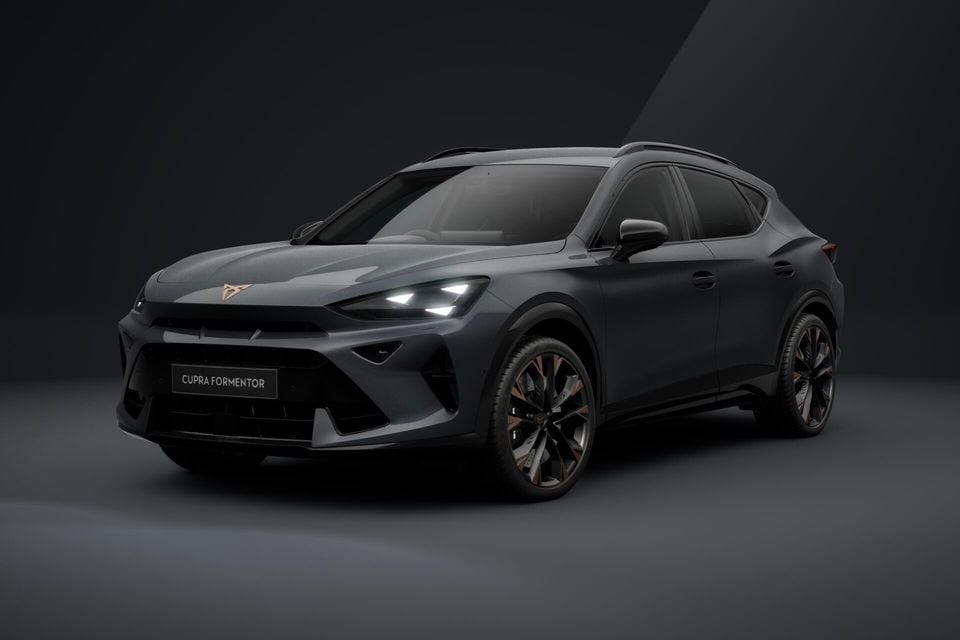A dark grey 2026 Cupra Formentor SUV shown from the front-side angle in a studio setting