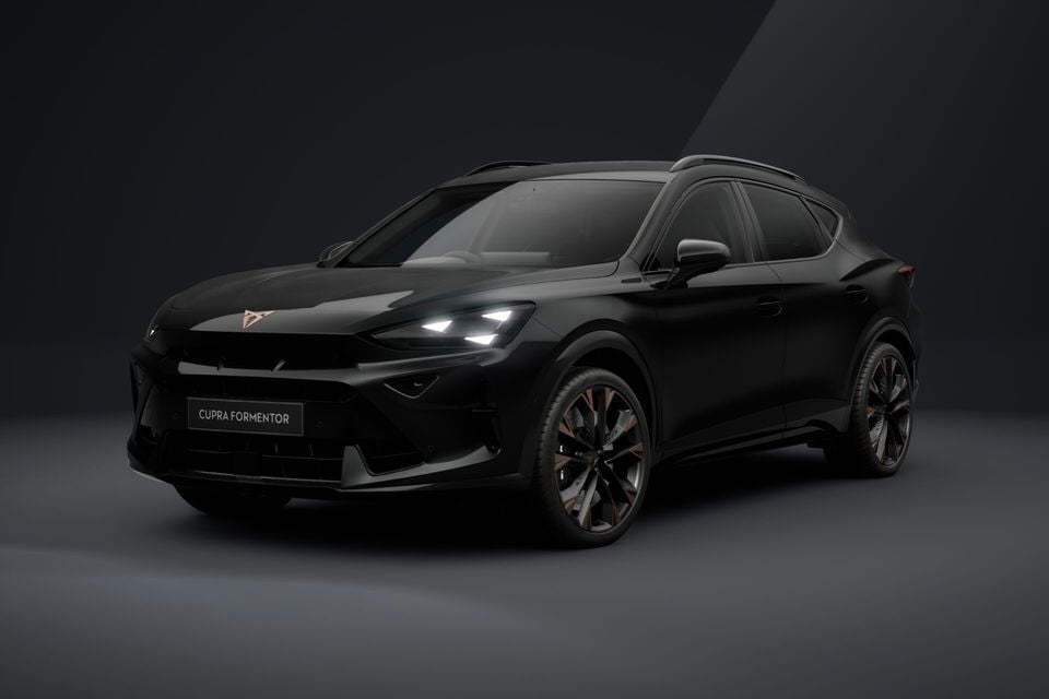 A black 2026 Cupra Formentor SUV photographed from the front three-quarter angle in a dark studio setting