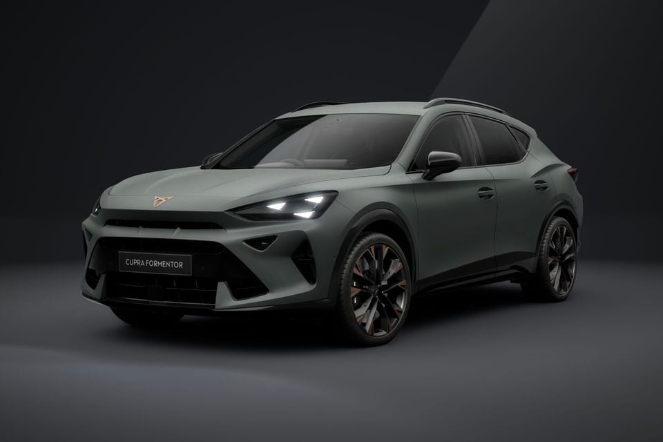 A green-grey 2026 Cupra Formentor SUV seen from the front three-quarter angle in a studio setting