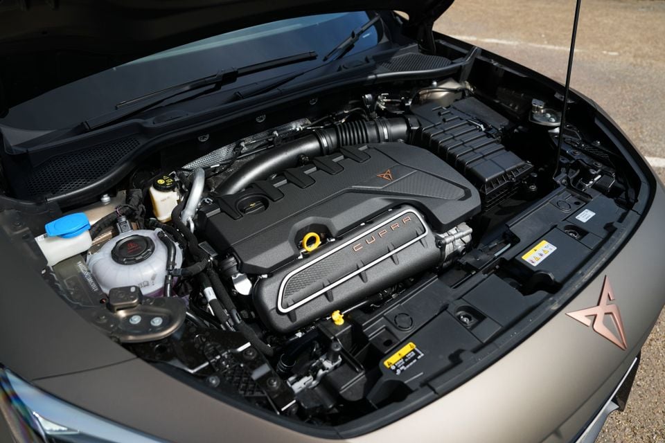The engine bay of a Cupra Formentor VZ5, showing the Cupra-branded engine cover with the copper logo and lettering
