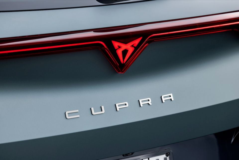 Close-up of the rear badge and tail light strip on a Cupra Formentor VZx, showing the illuminated Cupra logo and letter badging on a grey body panel
