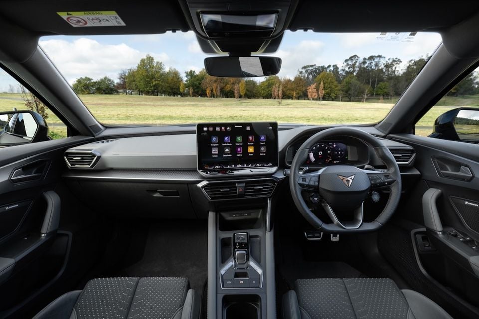 Interior of a 2026 Cupra Formentor VZX showing the dashboard, central touchscreen infotainment system, digital instrument cluster, and steering wheel with Cupra logo, right-hand drive