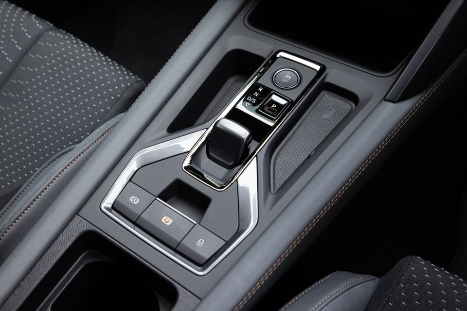 Close-up of the centre console gear selector and control buttons inside the 2026 CUPRA Formentor VZX, with orange contrast stitching visible on the seats