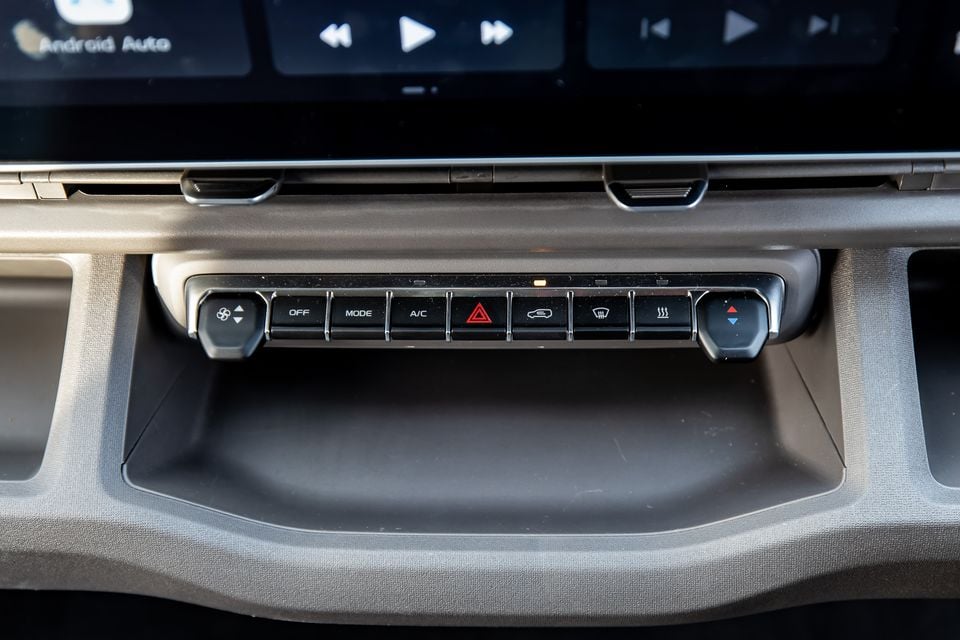 Close-up of the climate control and hazard button panel below the infotainment screen in a 2026 Farizon V7E, showing fan, mode, A/C, hazard, and demister controls