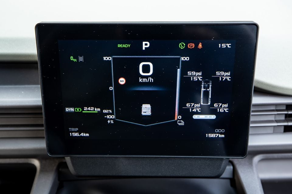 A digital instrument cluster display in a Farizon V7E showing speed, battery range of 242km, tyre pressure readings, and trip information while parked.