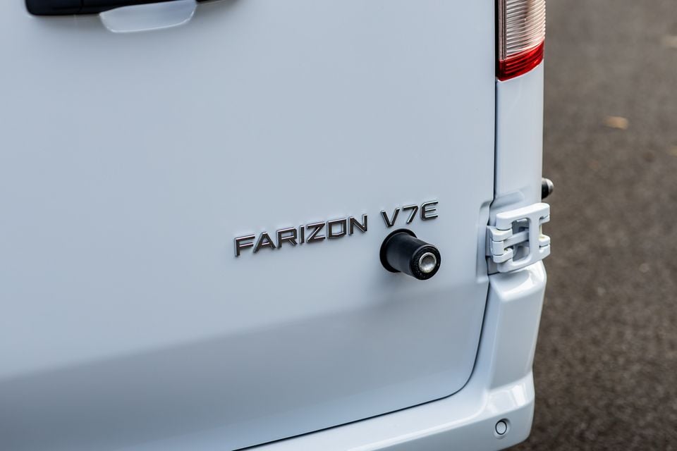 Close-up of the rear door badge and reversing camera on a white Farizon V7E van