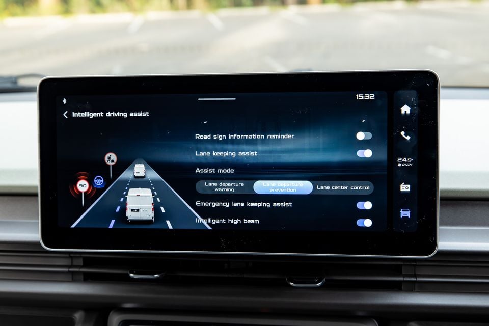Car infotainment touchscreen displaying the Intelligent Driving Assist settings menu, showing options including lane keeping assist, emergency lane keeping assist, and intelligent high beam.