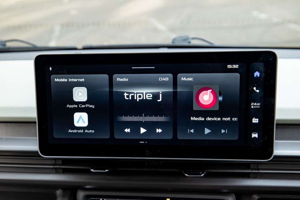 A car infotainment touchscreen showing Apple CarPlay, Android Auto, DAB radio tuned to triple j, and a music panel