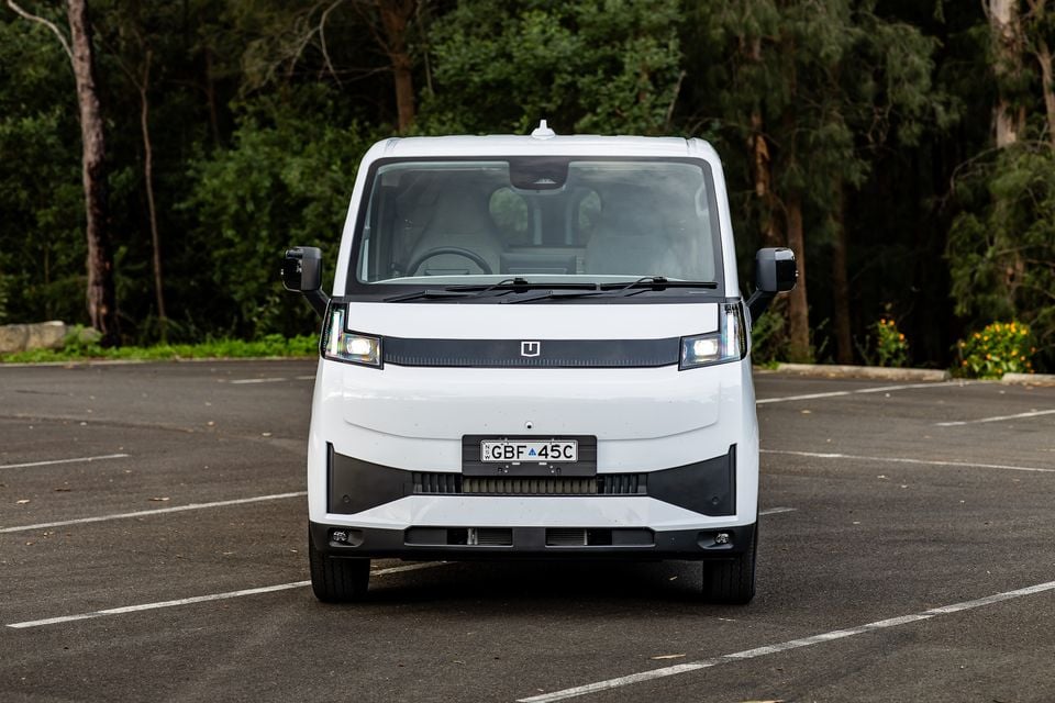 A white 2026 Farizon V7E van seen from the front, parked in a car park with trees in the background