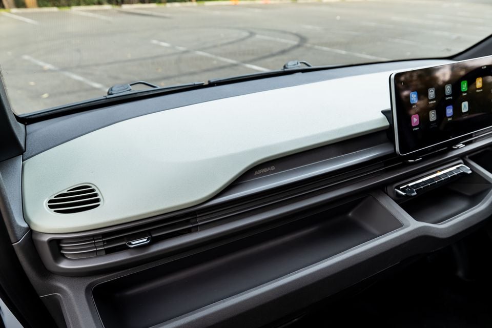 Interior dashboard of the 2026 Farizon V7E showing a light-coloured dash panel, air vent, and touchscreen infotainment display