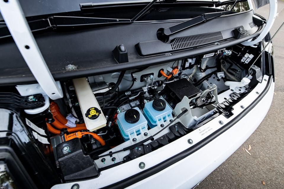 Under-bonnet view of the 2026 Farizon V7E electric van, showing orange high-voltage cabling, fluid reservoirs, and electrical components