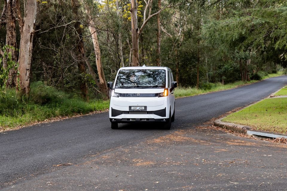 A white 2026 Farizon V7E van seen from the front on a quiet tree-lined road in Australia