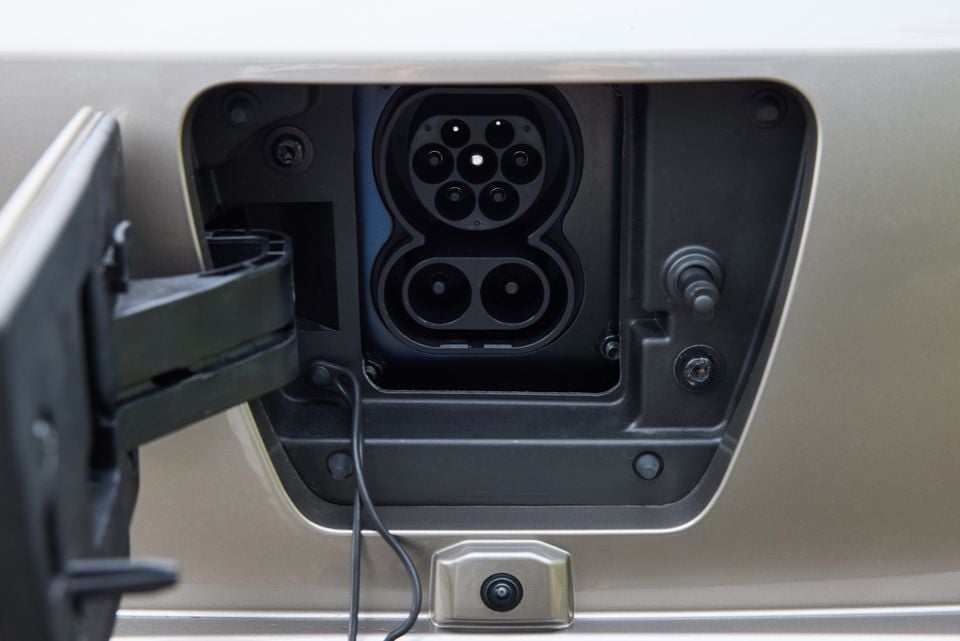 Close-up of a CCS2 combo charging port on a Forthing Taikon 5 electric vehicle, with the charge flap open