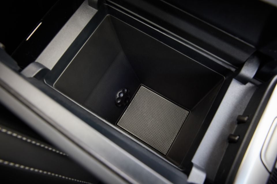 Open centre console storage compartment of the 2026 Forthing Taikon 5, showing a rubber mat lining the base