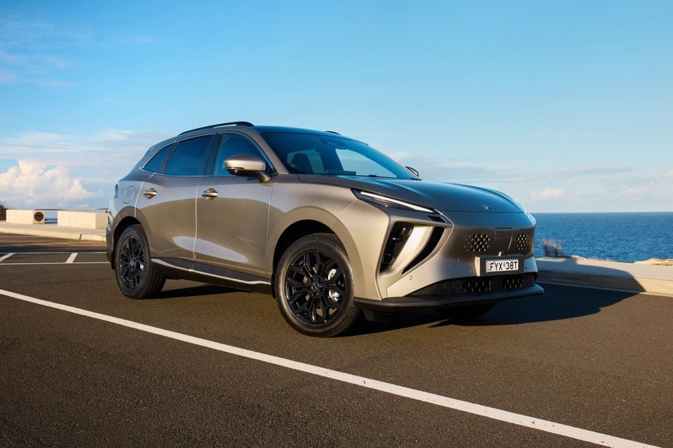 A silver Forthing Taikon 5 SUV parked near the coast, seen from the front-left side