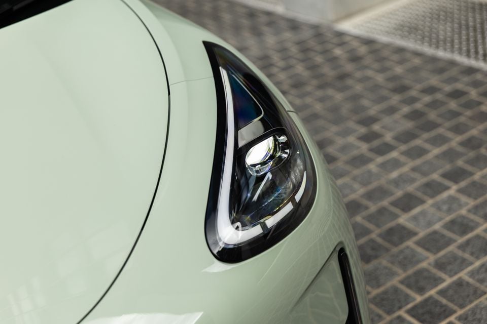 Close-up of the headlight on a light green Geely EX2 Inspire