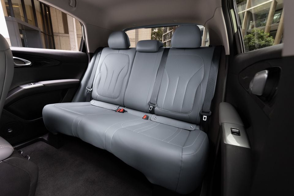 Rear interior of the 2026 Geely EX2 Inspire showing grey leather rear bench seat with three seatbelts