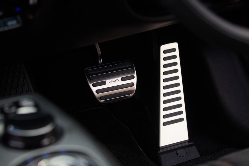 Aluminium sport pedals with Genesis branding inside a Genesis GV60 Magma