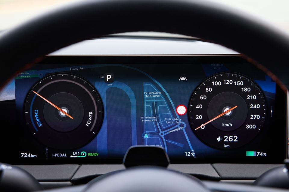 Digital instrument cluster of the 2026 Genesis GV60 Magma showing a power and charge gauge, speedometer up to 300 km/h, navigation map, 74% battery charge, and 262km estimated range