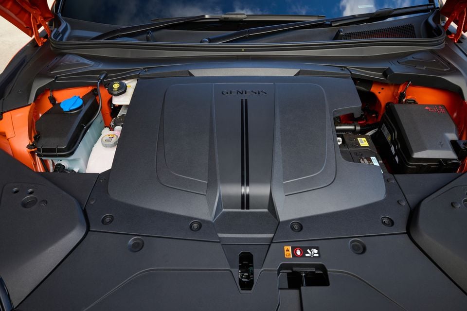 Genesis GV60 Magma engine bay showing the branded engine cover with Genesis lettering