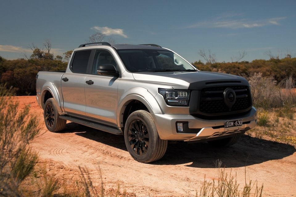 A silver 2026 GWM Cannon Alpha dual-cab ute parked on a dirt track, seen from the front quarter.