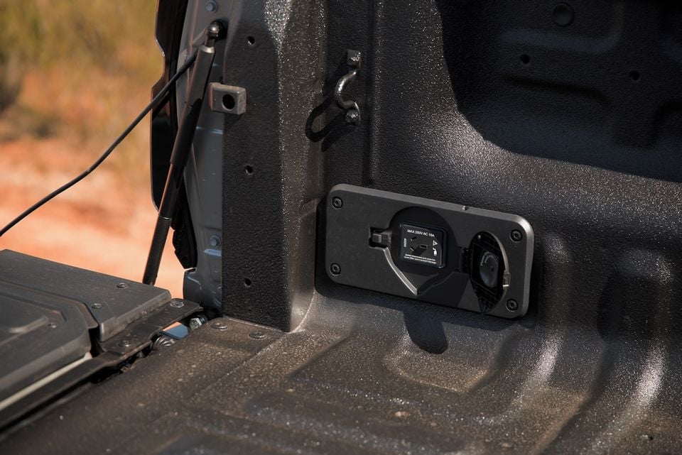 A close-up view of a 240-volt power outlet installed in the tub of a 2026 GWM Cannon Alpha ute.