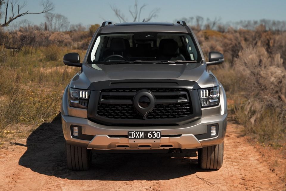 A grey 2026 GWM Cannon Alpha ute seen head-on, parked on a dirt track in the Australian outback