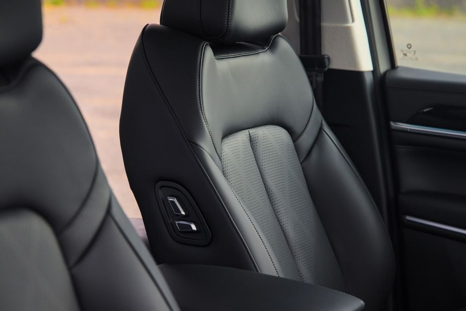 Close-up of a black leather front seat with perforated centre panel and seat adjustment buttons inside a 2026 GWM Cannon Alpha