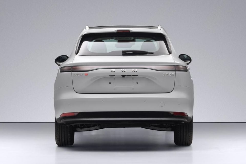 Rear view of a silver GWM ORA 5 GT PHEV SUV in a studio setting