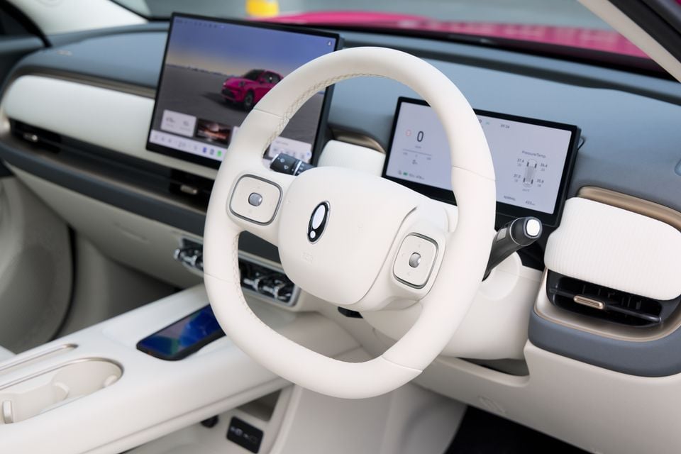 White steering wheel and dual touchscreen infotainment setup inside the 2026 GWM ORA 5 SUV