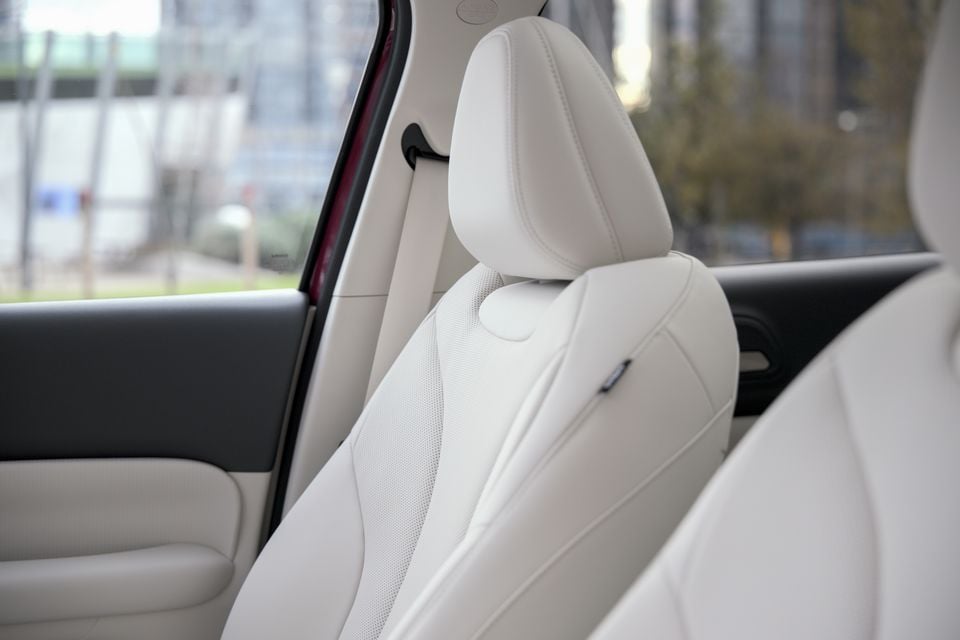 Light beige leather front seat interior of the 2026 GWM ORA 5 SUV, viewed from the rear seat