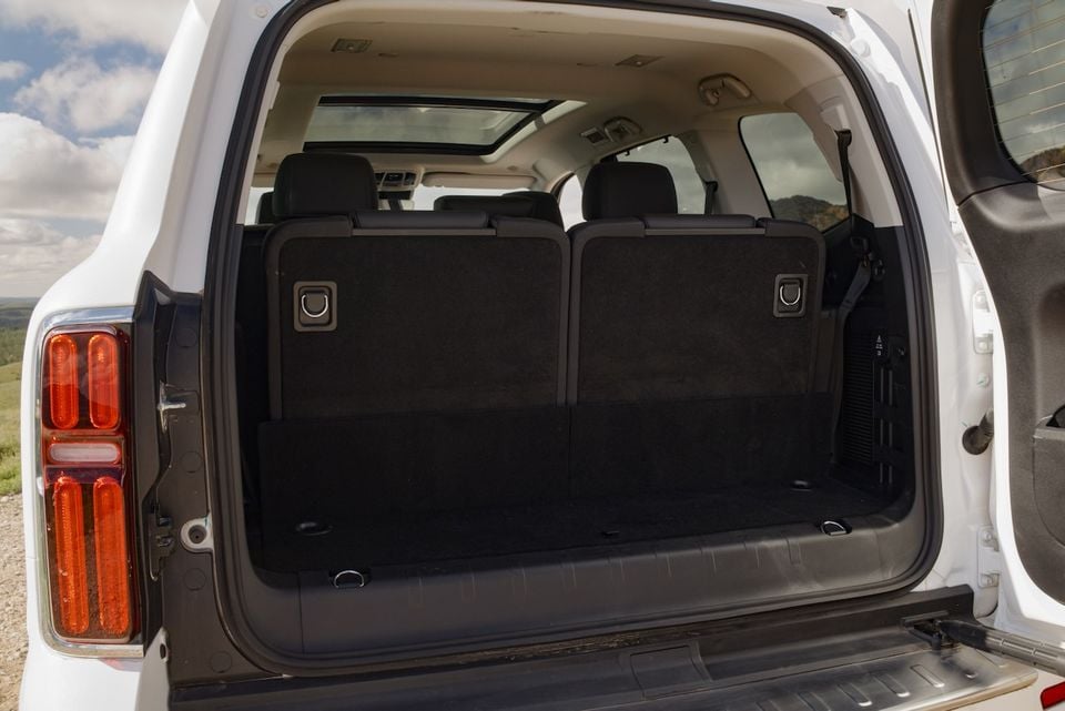 The open boot of a white 2026 GWM Tank 500 SUV, showing the empty cargo area with rear seats folded flat