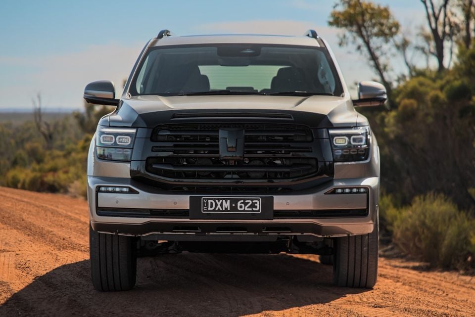 A silver 2026 GWM Tank 500 SUV photographed head-on while parked on a dirt road in the outback.