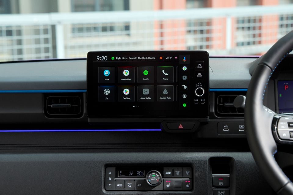 The infotainment touchscreen and climate control panel inside a 2026 Honda Super One, showing the Android Auto and Apple CarPlay home screen.