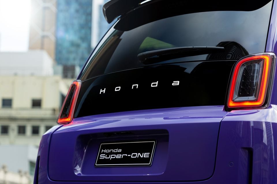 Close-up of the rear taillight and Honda badge on a purple 2026 Honda Super-ONE electric hatchback.